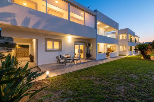 a large house with a lawn in front of it at Island Hills in Rhodes Town