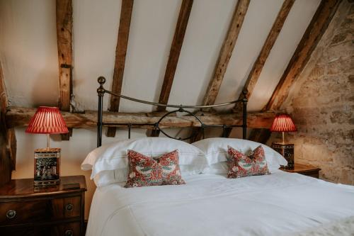 a bedroom with a white bed with two lamps at Allington Manor in Allington