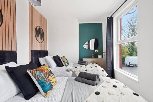 a bedroom with two beds and a large window at The Scandi Gem of Nottingham - Sleeps 10 in Nottingham