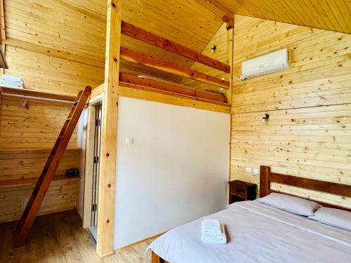 a bedroom with a bed in a wooden cabin at Cabana Bahna 2 in Orşova