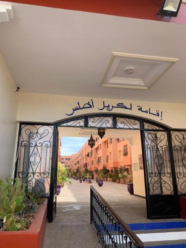 an entrance to a building with a gate with writing on it at Lovely 2-bedroom appartement in Marrakech