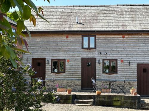 a house with brown doors and a building at The Calf Cotts in Pembridge