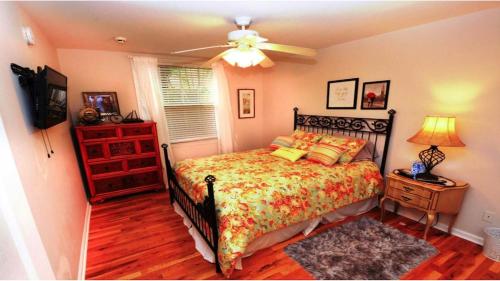 a bedroom with a bed and a ceiling fan at Case de León from the 1920's is a piece of Floridas relaxing history in West Palm Beach