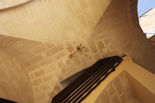 a clock on the ceiling of a building at Gli Archi garden rooms in Favignana