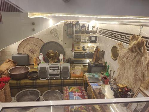 a kitchen with a counter with a microwave and other items at Dar Al Salaam Hospitality House in Nizwa