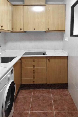 a kitchen with a washer and dryer in it at Apartamento Perelló in El Perelló