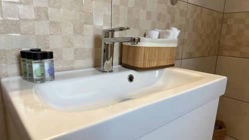 a sink with a faucet in a bathroom at Leo House Kea in Korissia