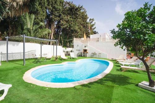 a swimming pool in the middle of a yard at Rancho Grande in Marbella