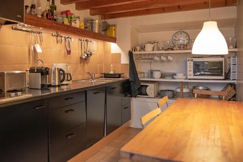 uma cozinha com uma mesa de madeira e uma bancada em Le Garage em Paris