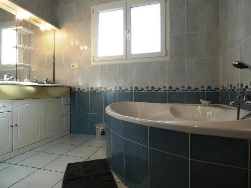 een badkamer met een bad en een wastafel bij La maison d'audignon in Audignon