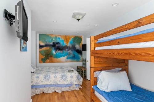 Beach House في Amagansett: غرفة نوم بسريرين بطابقين وتلفزيون