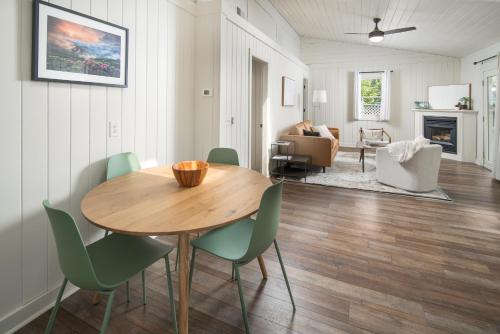 a living room with a wooden table and chairs at The Victorian Inn Blowing Rock in Blowing Rock