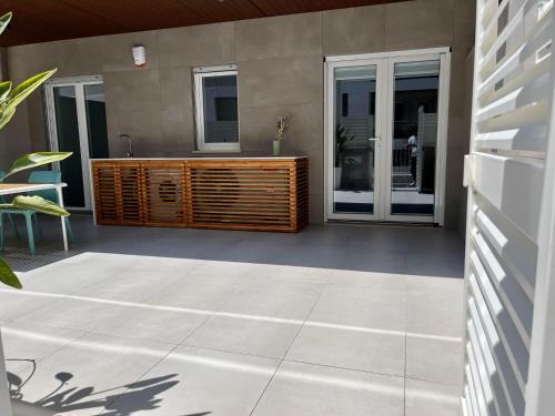a patio with a wooden unit on the side of a house at SeaCity Vibes Apartments in Monopoli