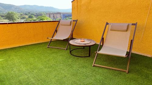 2 sillas y una mesa en el balcón en Sonora Golf and rest apartment, en Santa Cristina d'Aro