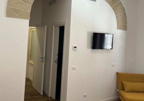 a television hanging on a wall in a room at A' BITTA in Favignana