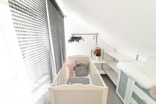 a baby crib in a room with a staircase at Einzigartiger Panoramablick zur Schwäbische Alb 