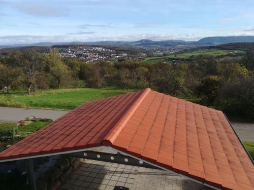 a red tile roof on a building with a view at Einzigartiger Panoramablick zur Schwäbische Alb in Altenriet