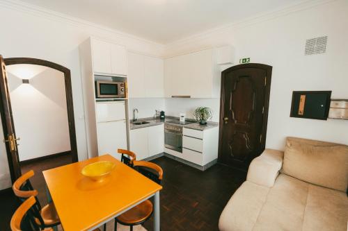 a small living room with a table and a couch at Quinta da Costinha in Alijó