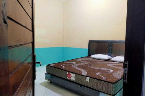 a bedroom with a bed in a room at EXPRESS O 91938 Grace Kost & Hostel in Balangdua