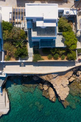 an aerial view of a house with a body of water at Spilia Retreat in Kamares