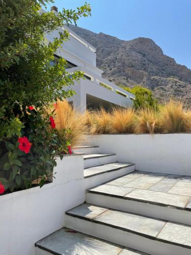 a staircase leading to a house with flowers at Spilia Retreat in Kamares