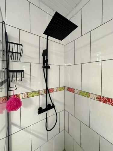 a bathroom with a shower with a shower head at Kapumati Villa - Évasion en Martinique in Sainte-Anne