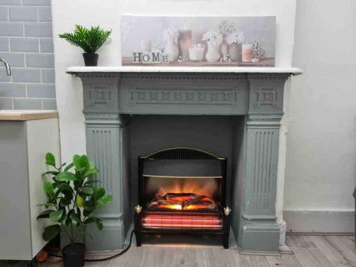 a fireplace in a living room with a fire place at Nice Flat near Central London in London