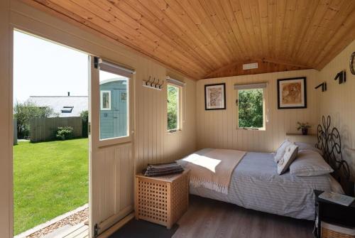 a bedroom with a bed in a house at Safari Cornwall in Bodmin