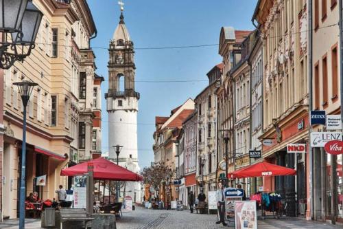 a city street with a clock tower in the distance at Apartment Scandic Living in Bautzen