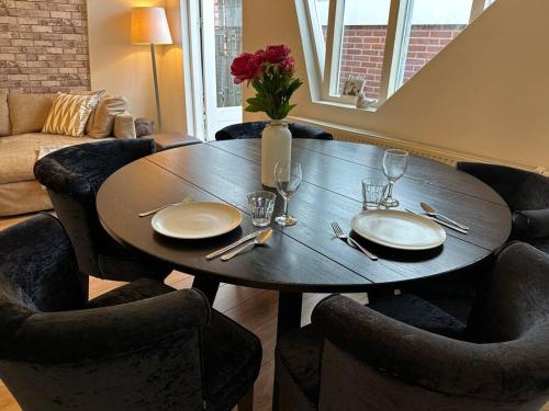 a dining room table with plates and wine glasses at Beach nearby, close to Amsterdam, The Hague -6p in Wassenaar