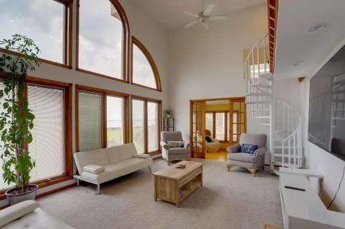 a living room filled with furniture and windows at Waterfront Luna Pier Home 14 Mi to Downtown Toledo in Erie