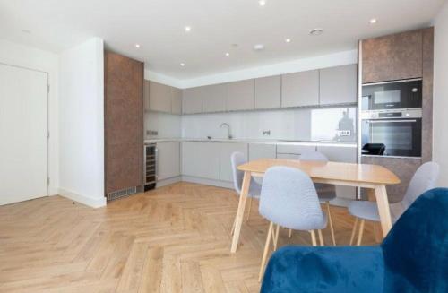 a kitchen and dining room with a table and chairs at Panoramic Views High Floor Apartment in Manchester