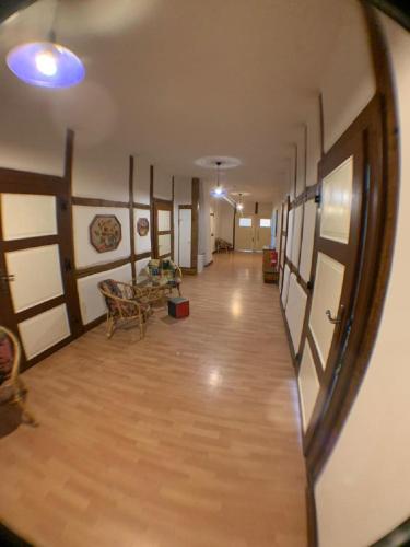 an empty room with a hallway with tables and chairs at Gutshausferien im Ostseehinterland in Thelkow