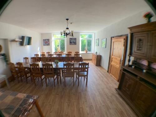 a dining room with a large table and chairs at Gutshausferien im Ostseehinterland in Thelkow