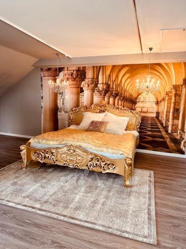 a bedroom with a king sized bed and a chandelier at Ferienwohnung Honeymoon Deluxe Wellness mit Sauna auf Schloss Falkenhorst in Kleinblittersdorf