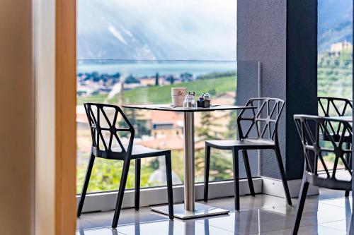 a table and chairs in front of a window at GARNI' FOCI in Riva del Garda