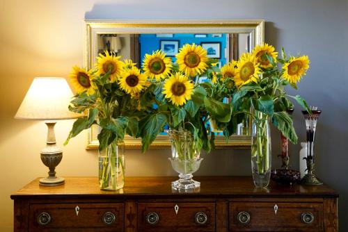 a bunch of sunflowers in vases on a dresser at The Old Stores in Montgomery