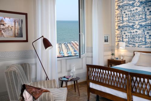 Schlafzimmer mit einem Bett und Meerblick in der Unterkunft Palace Hotel in Viareggio