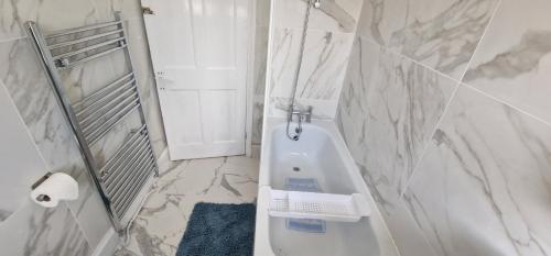 a bathroom with a toilet and a sink and a shower at Home In Harrow/Wembley in Harrow on the Hill