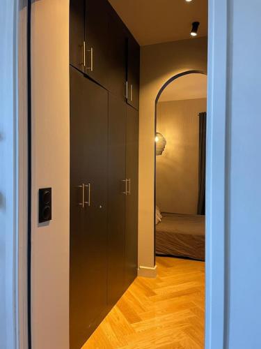 einen Flur mit einem Zimmer mit einem Bett und einem Spiegel in der Unterkunft Appartement plein de charme au cœur du Vieux-Lyon in Lyon