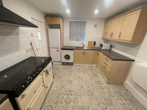 a small kitchen with a sink and a stove at Comfortable Midtown Retreat in Liverpool