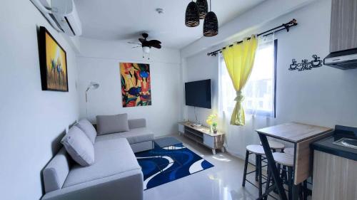 a living room with a couch and a table at Cozy almond drive condo in cebu in Talisay