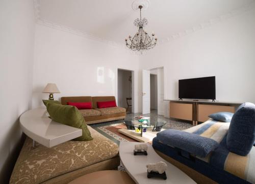 a living room with a couch and a tv at AM Apartment in Cosenza