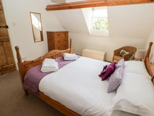 a bedroom with a large bed and a window at The Coach House in Haverfordwest