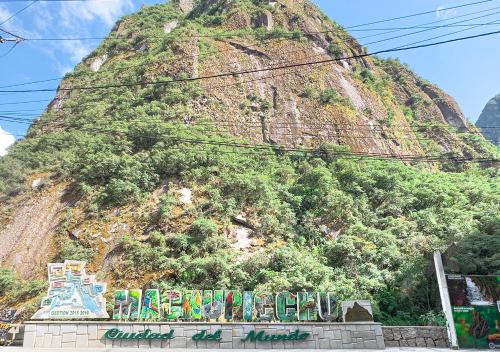 a large mountain with graffiti on the side of it at MACHUPICCHU BOUTIQUE in Machu Picchu