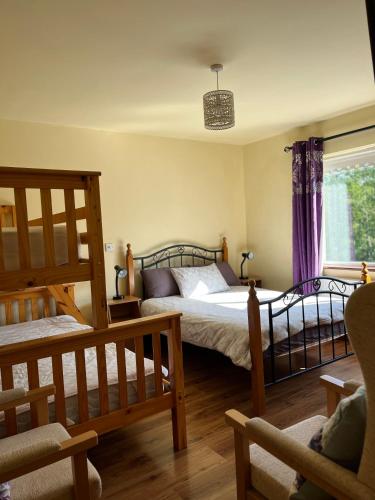 a bedroom with two beds and a window at Doughlasha House V93RX64 in Killarney