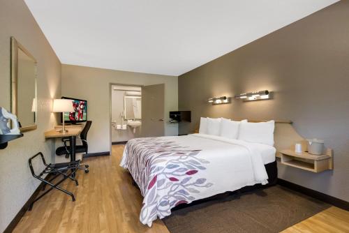 a hotel room with a bed and a desk at Red Roof Inn Asheville - Biltmore West in Asheville