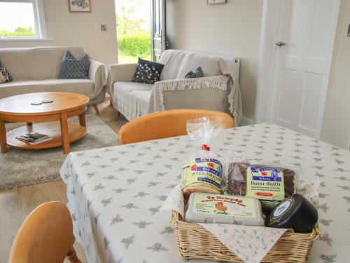 a living room with a table with a basket of food on it at Bethania in Oswestry