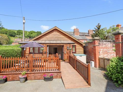 a house with a wooden deck with an umbrella at Varley Villa in Newtown