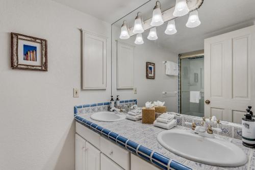 baño con 2 lavabos y espejo grande en Interlude Condominiums 3-Bedroom Unit 302 en Snowmass Village